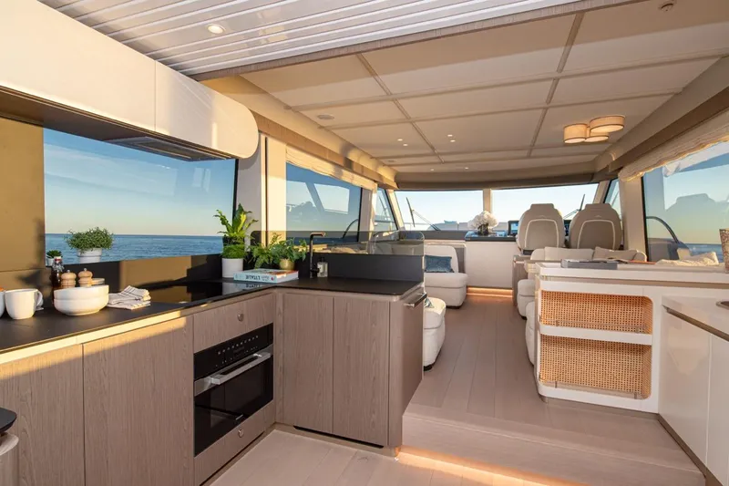  Yacht Photos Pics Luxurious interior of 2025 Azimut Magellano 60 yacht with modern kitchen and seating area.
