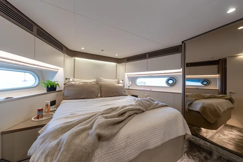  Yacht Photos Pics Luxurious bedroom interior of 2025 Azimut Magellano 60 yacht with modern design and cozy bedding.