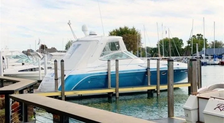 Gracie B Yacht Photos Pics 2006 Formula 40 PC yacht docked in a marina, featuring a sleek blue and white design.