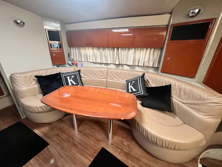 Gracie B Yacht Photos Pics Luxurious interior of a 2006 Formula 40 PC yacht with leather seating and wooden table.