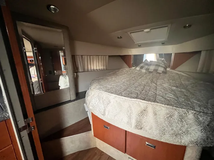 Gracie B Yacht Photos Pics Interior cabin of a 2006 Formula 40 PC yacht with a cozy bed and wooden storage.