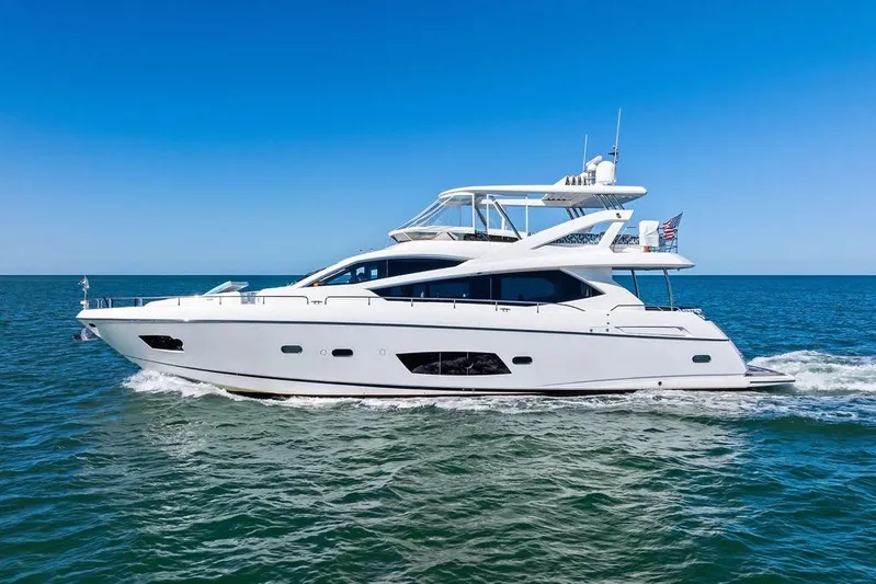 It's Enough Yacht Photos Pics 2013 Sunseeker Manhattan 73 yacht cruising on open sea under clear blue sky.