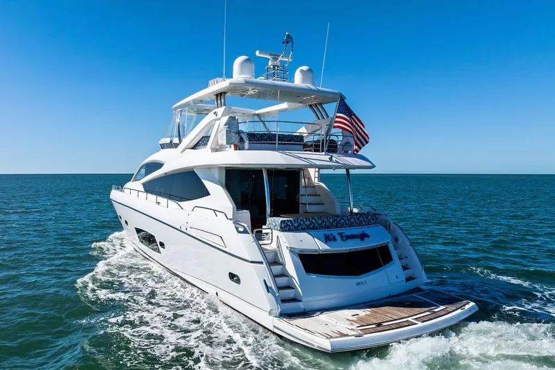 It's Enough Yacht Photos Pics 2013 Sunseeker Manhattan 73 yacht cruising on open sea under clear blue sky.