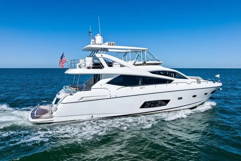 It's Enough Yacht Photos Pics 2013 Sunseeker Manhattan 73 yacht cruising on open sea under clear blue sky.