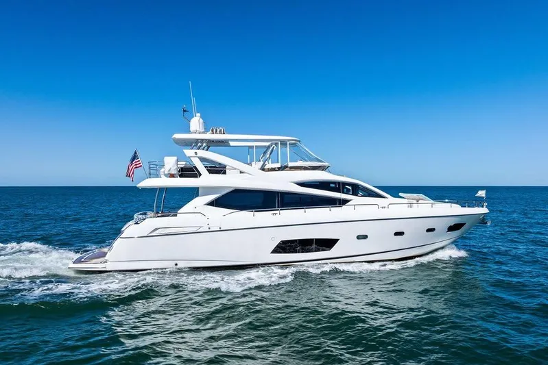 It's Enough Yacht Photos Pics 2013 Sunseeker Manhattan 73 yacht cruising on open sea under clear blue sky.