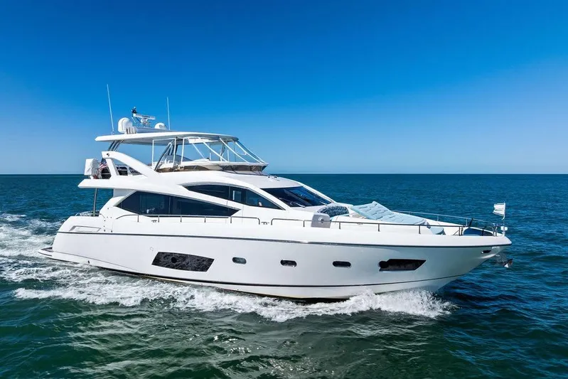 It's Enough Yacht Photos Pics Luxurious 2013 Sunseeker Manhattan 73 yacht cruising on open sea under clear blue sky.