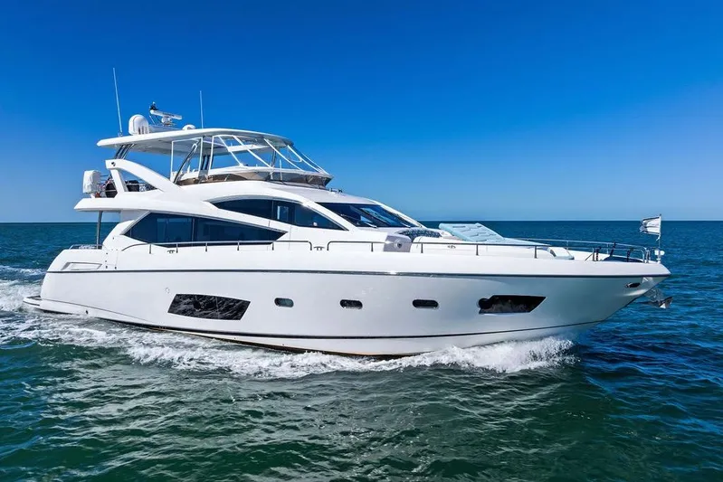 It's Enough Yacht Photos Pics 2013 Sunseeker Manhattan 73 yacht cruising on open sea under clear blue sky.