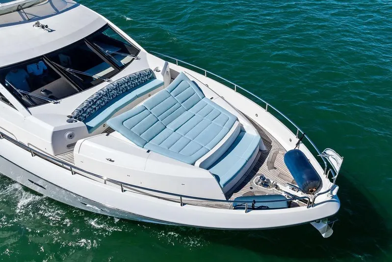 It's Enough Yacht Photos Pics 2013 Sunseeker Manhattan 73 yacht with luxurious deck seating on open water.