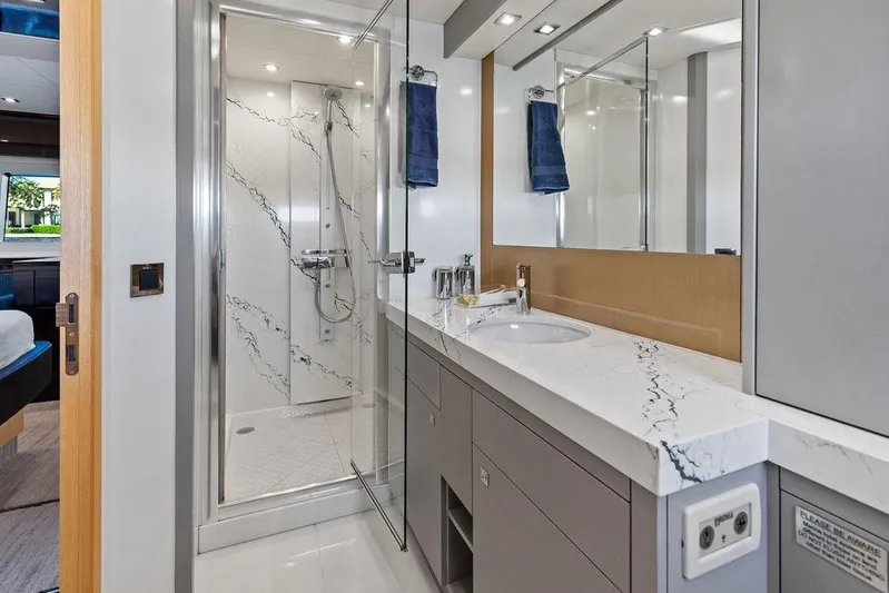It's Enough Yacht Photos Pics Luxurious bathroom in 2013 Sunseeker Manhattan 73 yacht with marble accents and modern fixtures.