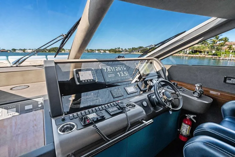 It's Enough Yacht Photos Pics Cockpit of 2013 Sunseeker Manhattan 73 yacht with navigation controls and scenic water view.