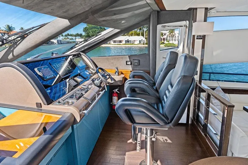 It's Enough Yacht Photos Pics Luxurious interior of 2013 Sunseeker Manhattan 73 yacht with modern helm and leather seating.