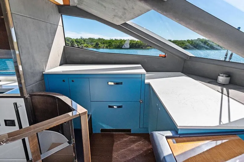 It's Enough Yacht Photos Pics Interior of 2013 Sunseeker Manhattan 73 yacht with modern cabinetry and scenic window view.