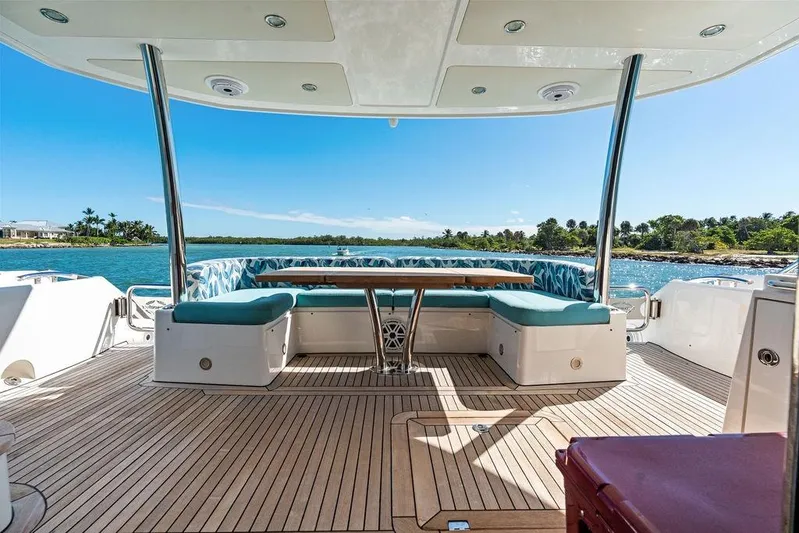 It's Enough Yacht Photos Pics Luxurious Sunseeker Manhattan 73 yacht deck with seating, overlooking serene waters, 2013 model.