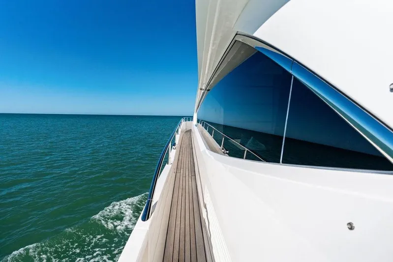 It's Enough Yacht Photos Pics 2013 Sunseeker Manhattan 73 yacht cruising on open sea under clear blue sky.