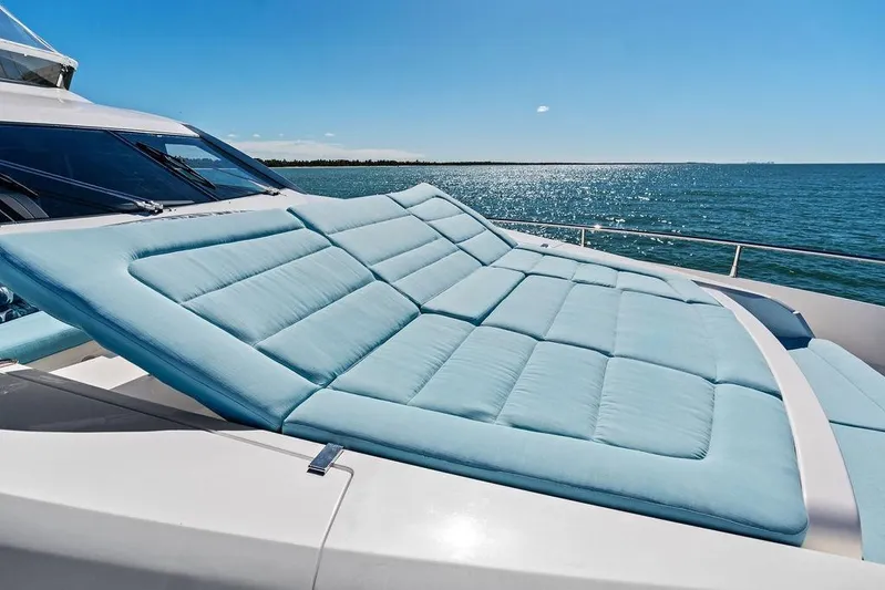 It's Enough Yacht Photos Pics Luxurious sunbed on 2013 Sunseeker Manhattan 73 yacht, overlooking serene ocean view.