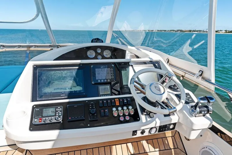 It's Enough Yacht Photos Pics Cockpit of 2013 Sunseeker Manhattan 73 yacht with navigation controls and ocean view.