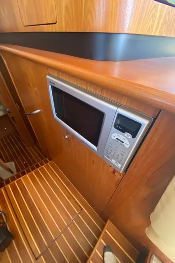 Reel Appeal Yacht Photos Pics Built-in microwave in the 2006 Tiara Sport 39 yacht's wooden interior.