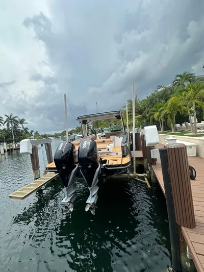  Yacht Photos Pics 2022 Aviara 32 boat docked, featuring dual outboard engines, surrounded by tropical scenery.