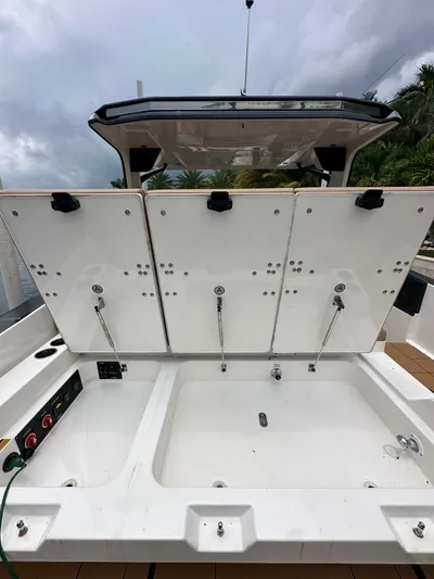  Yacht Photos Pics 2022 Aviara 32 boat with open storage compartments, showcasing spacious design and modern features.