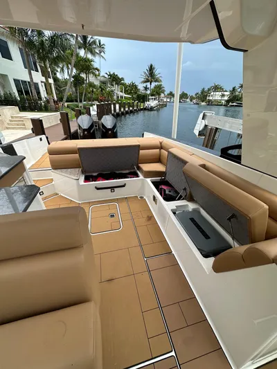  Yacht Photos Pics 2022 Aviara 32 boat interior with tan seating and open storage compartments.