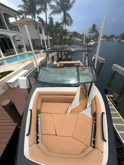  Yacht Photos Pics 2022 Aviara 32 boat docked by waterfront homes with palm trees.