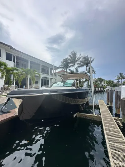  Yacht Photos Pics 2022 Aviara 32 boat docked by waterfront home with palm trees.