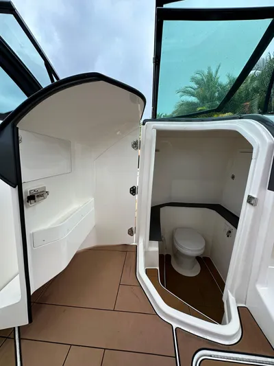  Yacht Photos Pics 2022 Aviara 32 boat interior with open bathroom door, showcasing modern design.