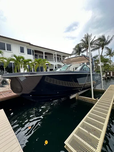  Yacht Photos Pics 2022 Aviara 32 boat docked near waterfront property with palm trees.