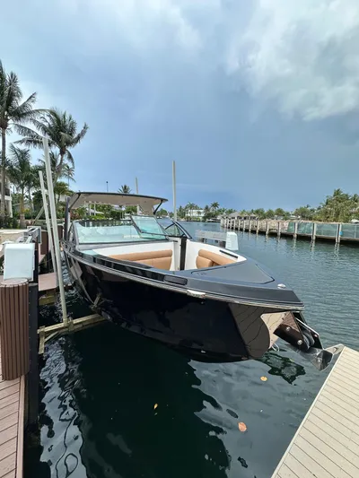  Yacht Photos Pics 2022 Aviara 32 boat docked by palm trees and waterfront homes.