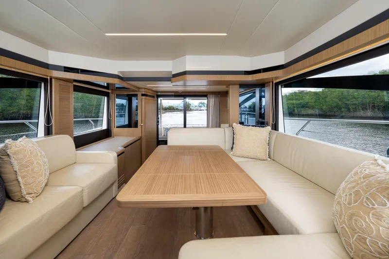 Four Sail Yacht Photos Pics Luxurious interior of 2020 Absolute Flybridge yacht with elegant seating and scenic views.