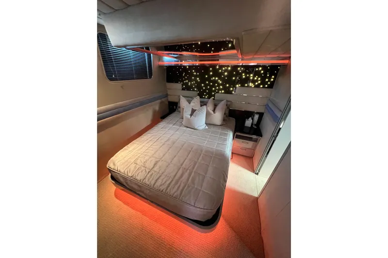 Fantom Yacht Photos Pics Luxurious bedroom interior of 1990 Tempest 60 Express yacht with ambient lighting.