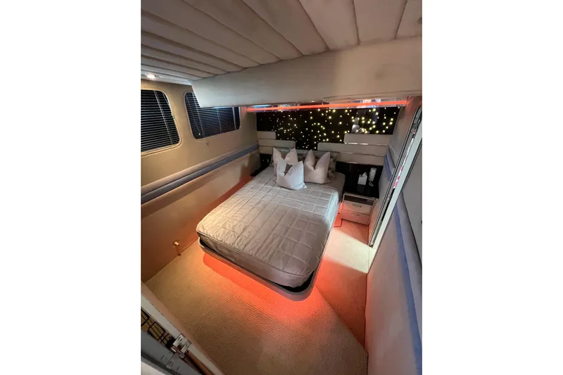 Fantom Yacht Photos Pics Luxurious 1990 Tempest 60 Express yacht bedroom with ambient lighting and modern decor.