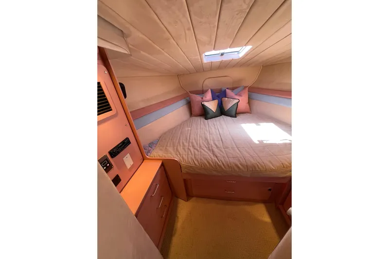 Fantom Yacht Photos Pics Cozy cabin interior of 1990 Tempest 60 Express yacht with bed and pillows.