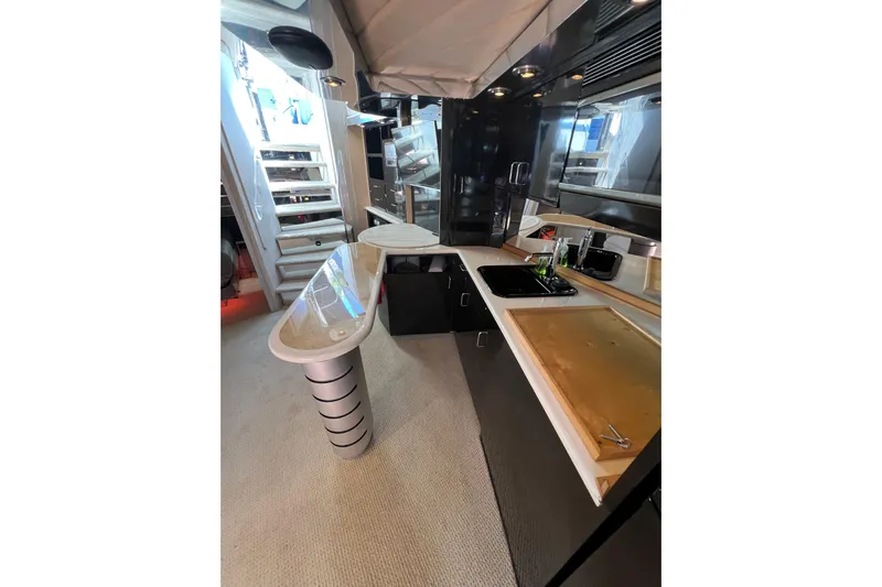 Fantom Yacht Photos Pics Luxurious 1990 Tempest 60 Express yacht interior with modern kitchen and sleek design.