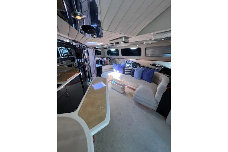 Fantom Yacht Photos Pics Luxurious interior of a 1990 Tempest 60 Express yacht with plush seating and modern design.