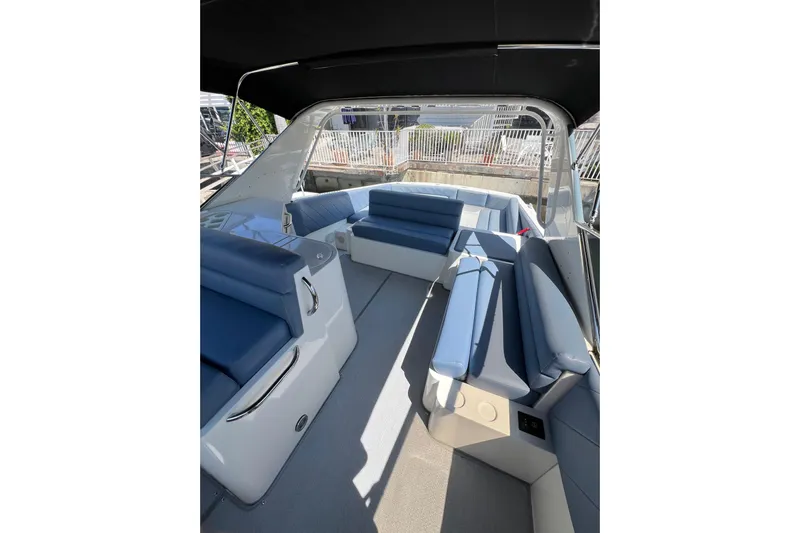 Fantom Yacht Photos Pics Spacious interior of 1990 Tempest 60 Express boat with blue seating and sleek design.