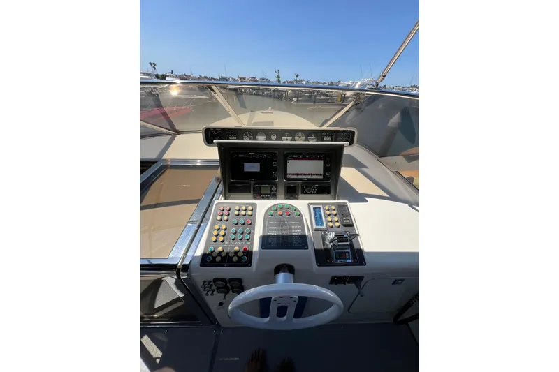 Fantom Yacht Photos Pics Cockpit of 1990 Tempest 60 Express yacht with control panel and steering wheel.
