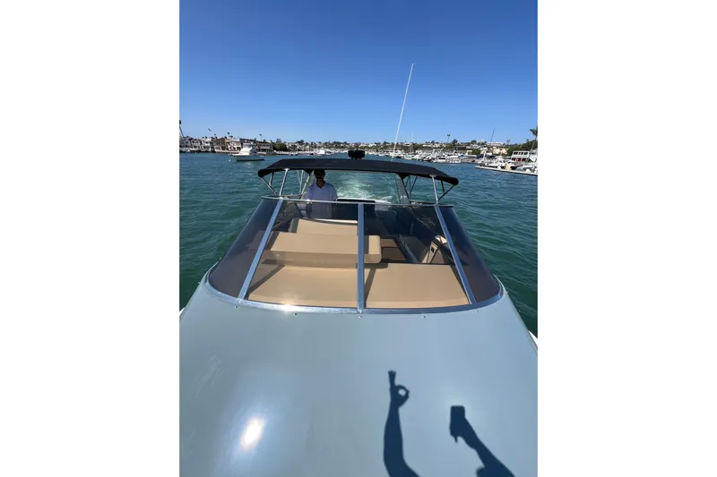 Fantom Yacht Photos Pics 1990 Tempest 60 Express boat cruising on a sunny day in a marina.