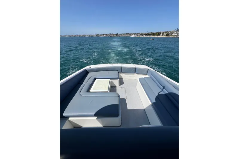 Fantom Yacht Photos Pics 1990 Tempest 60 Express yacht with spacious deck seating on open water.