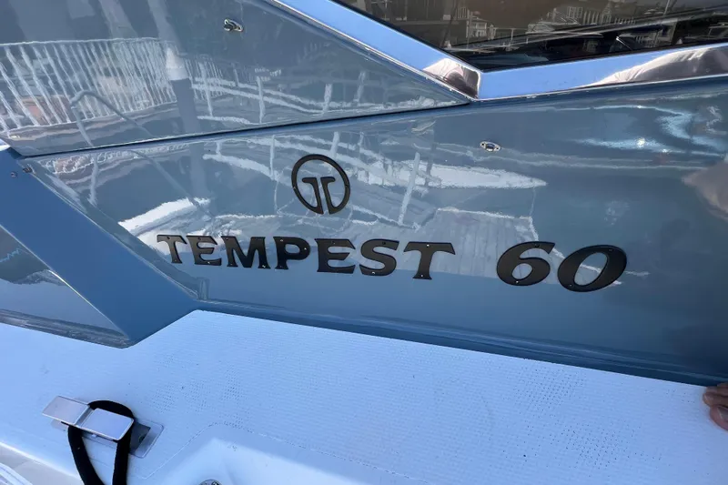 Fantom Yacht Photos Pics Side view of a 1990 Tempest 60 Express boat with logo and name.
