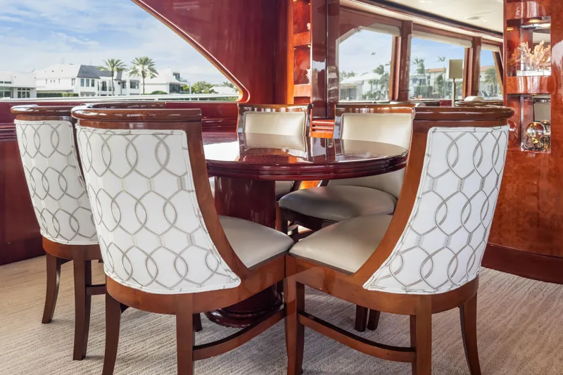  Yacht Photos Pics Luxurious dining area on 2005 Ocean Alexander 80 Motoryacht with elegant wood and upholstered chairs.