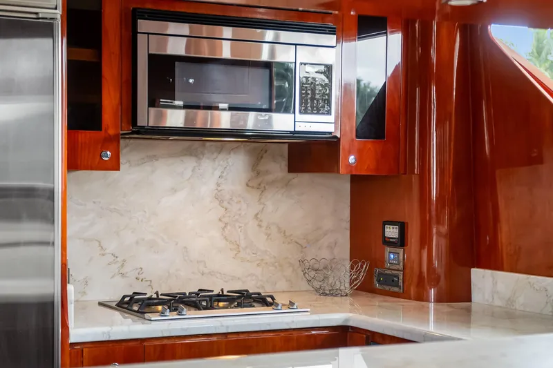  Yacht Photos Pics Luxurious kitchen interior of 2005 Ocean Alexander 80 Motoryacht with marble backsplash and modern appliances.