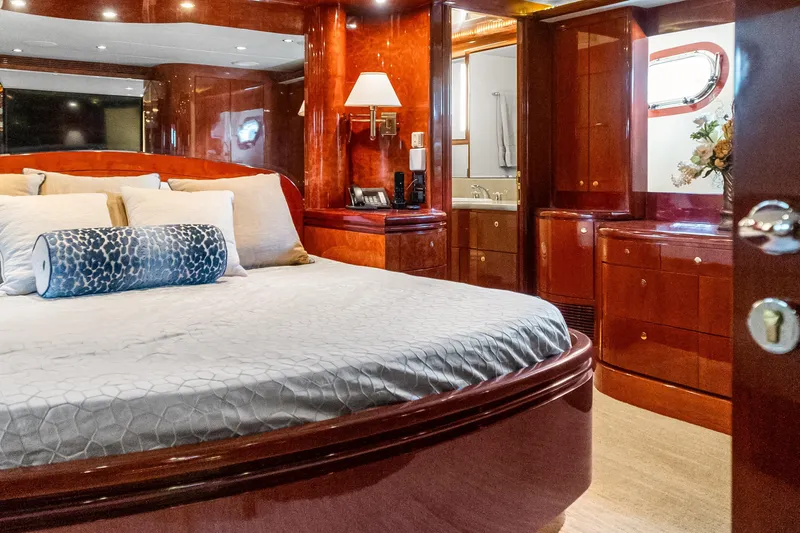  Yacht Photos Pics Luxurious bedroom interior of 2005 Ocean Alexander 80 Motoryacht with elegant wood finishes.