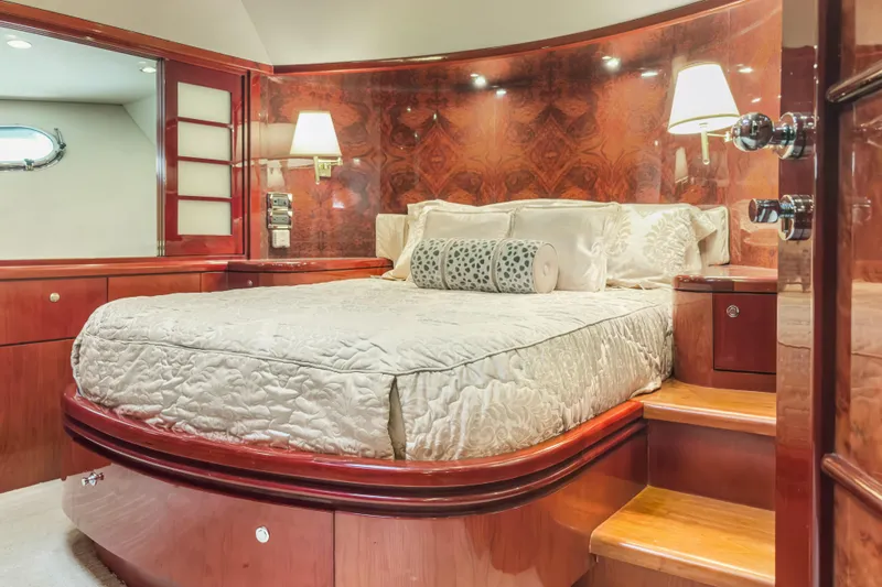 Yacht Photos Pics Luxurious bedroom interior of 2005 Ocean Alexander 80 Motoryacht with elegant wood finishes.