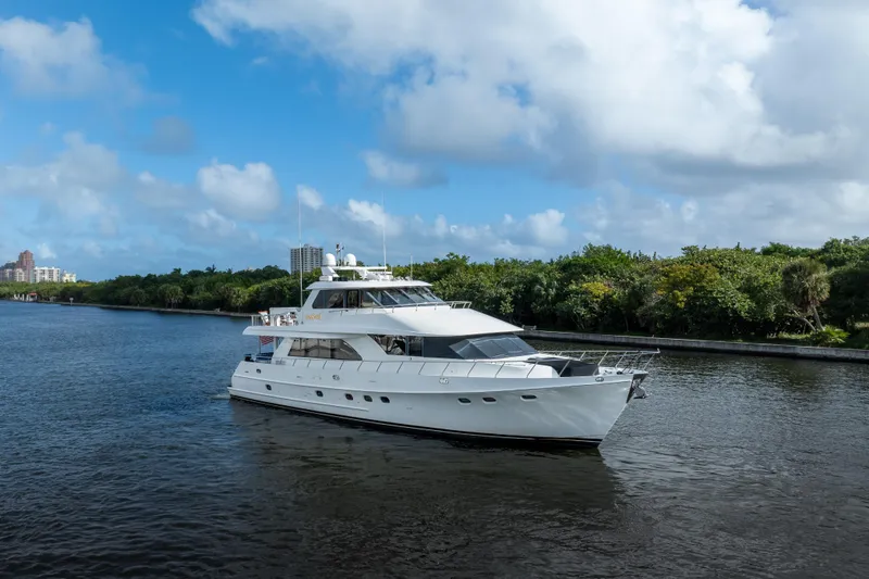  Yacht Photos Pics 2005 Ocean Alexander 80 Motoryacht cruising on a scenic waterway under a blue sky.