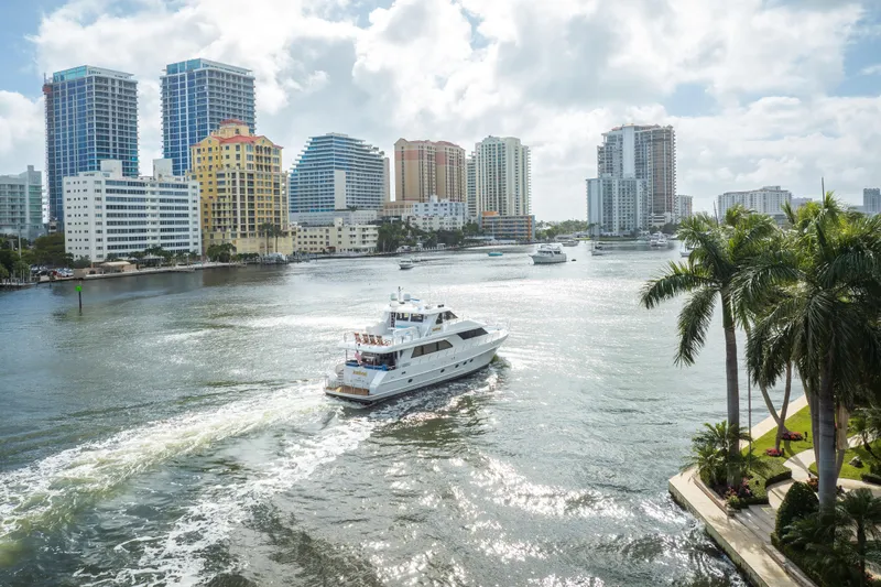  Yacht Photos Pics 2005 Ocean Alexander 80 Motoryacht cruising in a sunny urban waterway with skyscrapers.