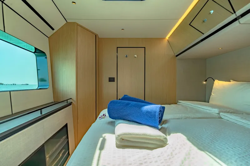 Jack Yacht Photos Pics Luxurious cabin interior of 2023 McConaghy MC75 yacht with modern design and cozy bedding.