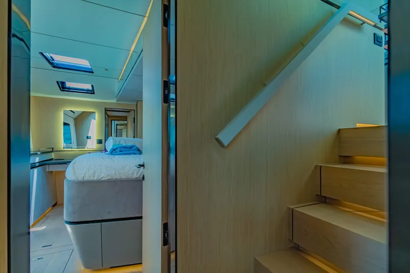 Jack Yacht Photos Pics Luxurious interior of 2023 McConaghy MC75 yacht with modern bedroom and staircase.
