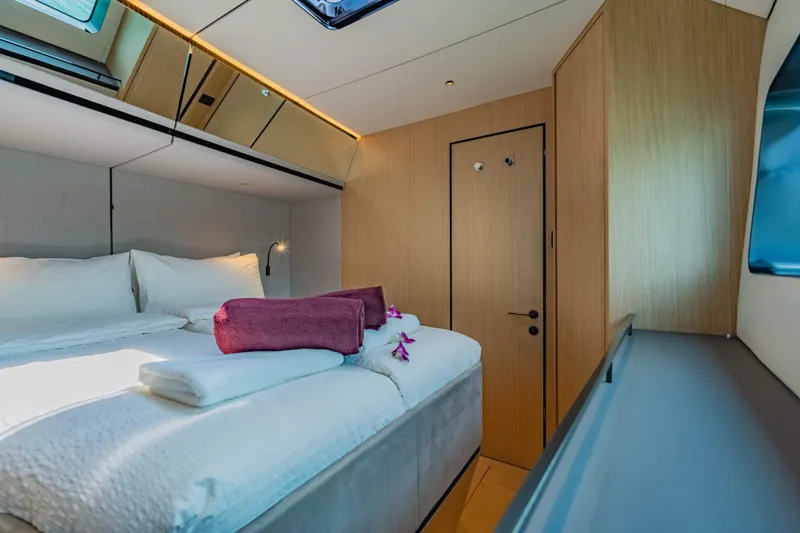 Jack Yacht Photos Pics Luxurious cabin interior of 2023 McConaghy MC75 yacht with plush bedding and modern design.