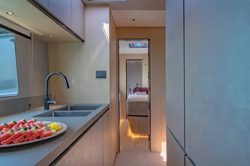 Jack Yacht Photos Pics Modern kitchen interior of 2023 McConaghy MC75 yacht with sleek design and watermelon slices.